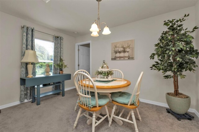 dining area featuring a chandelier and carpet