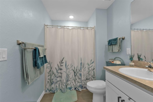 bathroom featuring a shower with shower curtain, vanity, toilet, and wood-type flooring