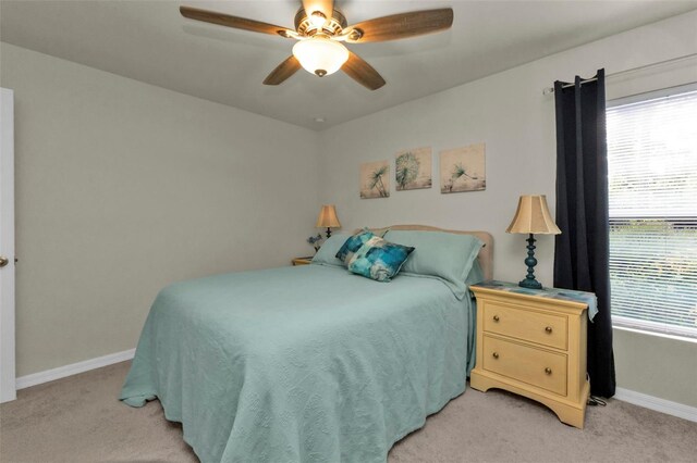 bedroom featuring light colored carpet and ceiling fan