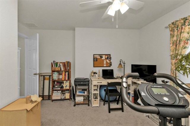 carpeted home office with ceiling fan