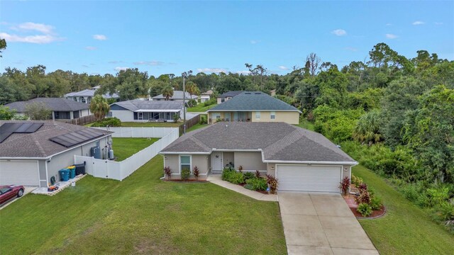 view of front of house featuring a front yard and a garage