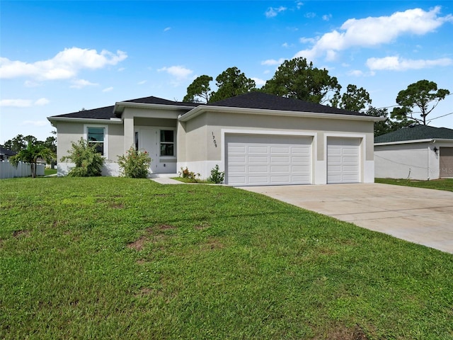 view of front of home with a front yard and a garage