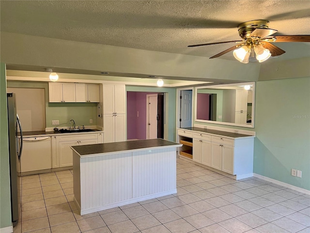 kitchen featuring white cabinetry, sink, and ceiling fan