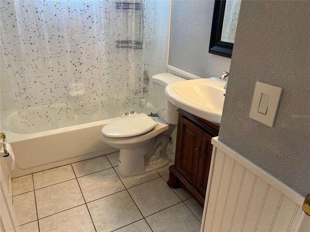 full bathroom with vanity, toilet, shower / tub combo with curtain, and tile patterned floors