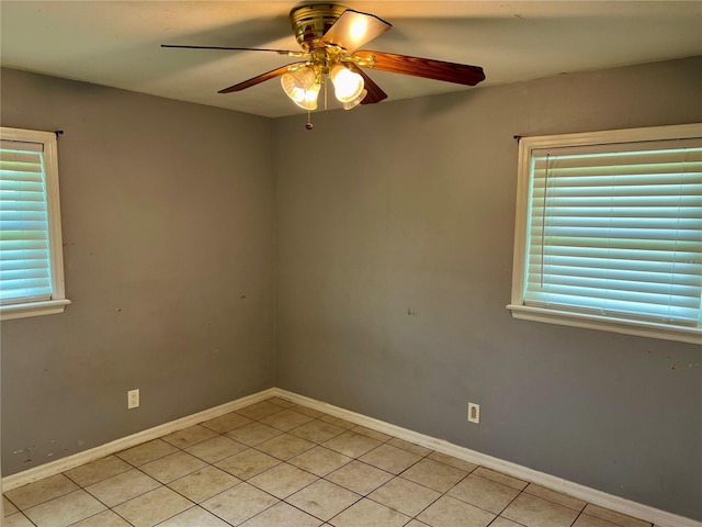 unfurnished room with ceiling fan and light tile patterned flooring