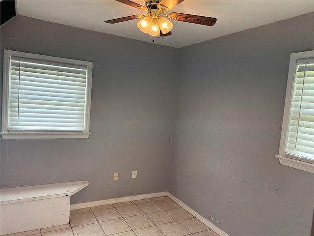 unfurnished room featuring plenty of natural light, ceiling fan, and light tile patterned floors