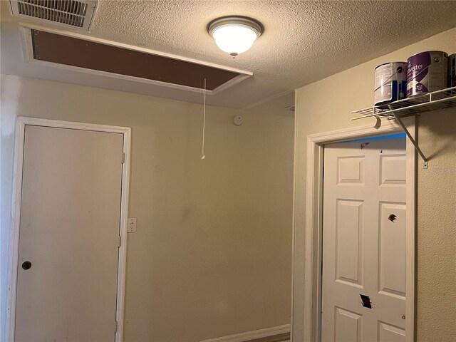 interior space with a textured ceiling