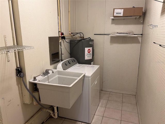 clothes washing area with light tile patterned floors, sink, and electric water heater