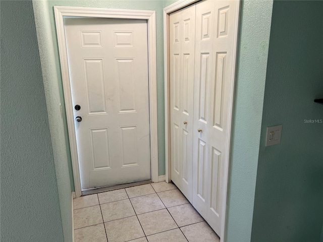 doorway with light tile patterned flooring