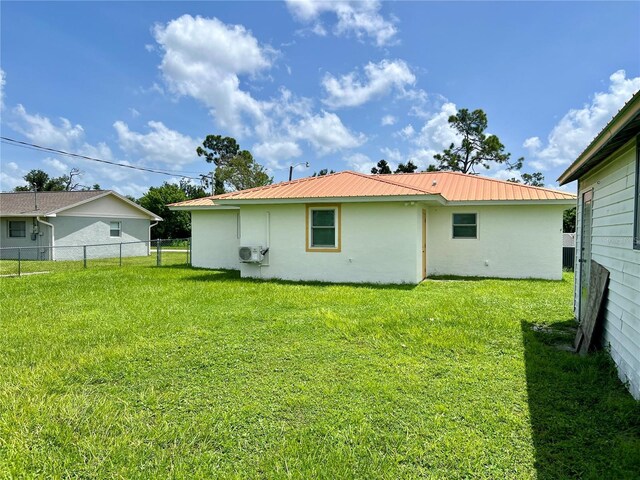 rear view of property with a yard