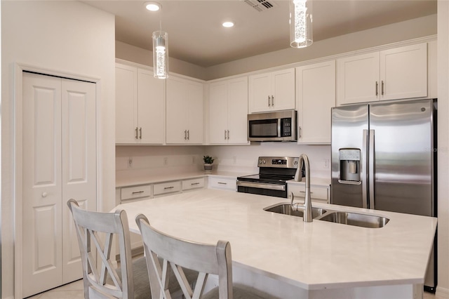 14131 Heritage Landing Blvd Unit 838, Punta Gorda, FL 33955 - kitchen featuring a sink, white cabinets, an island with sink, and stainless steel appliances