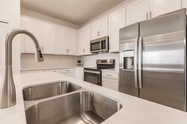 14131 Heritage Landing Blvd Unit 838, Punta Gorda, FL 33955 - kitchen with appliances with stainless steel finishes, white cabinetry, light countertops, and a sink