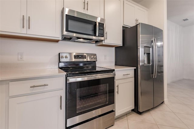 14131 Heritage Landing Blvd Unit 838, Punta Gorda, FL 33955 - kitchen featuring light tile patterned floors, white cabinetry, stainless steel appliances, and light countertops