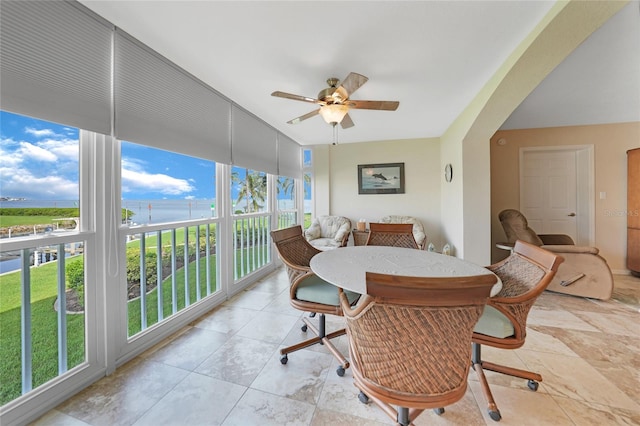 dining room with ceiling fan and expansive windows