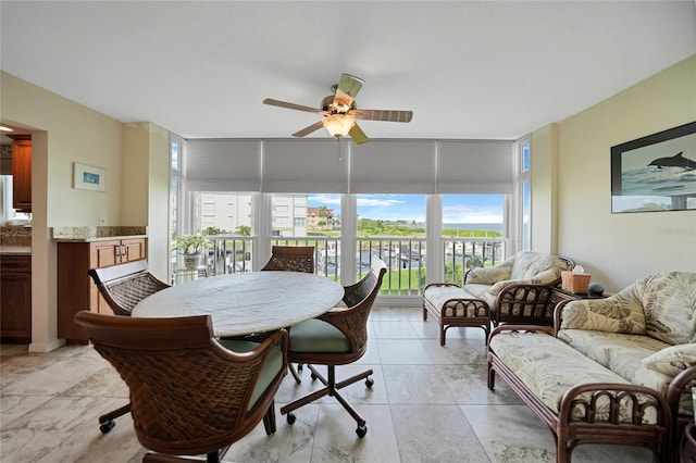 dining space with a healthy amount of sunlight, floor to ceiling windows, and ceiling fan