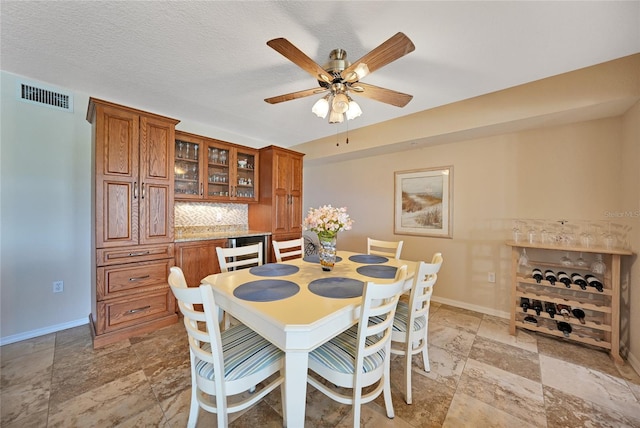 dining area featuring a textured ceiling and ceiling fan