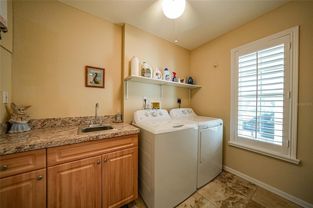 laundry room with cabinets, light tile patterned floors, washer and dryer, sink, and ceiling fan