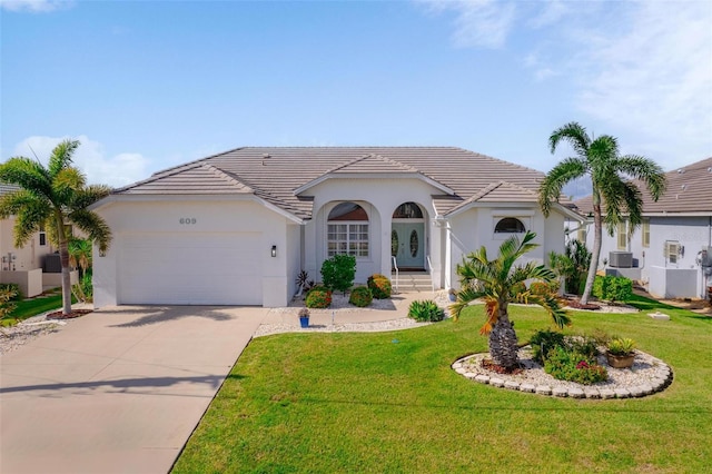 view of front of home with a garage and a front lawn