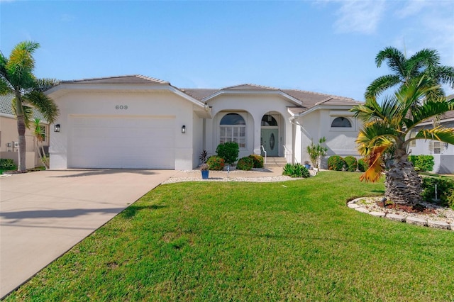 mediterranean / spanish-style home featuring a garage and a front lawn