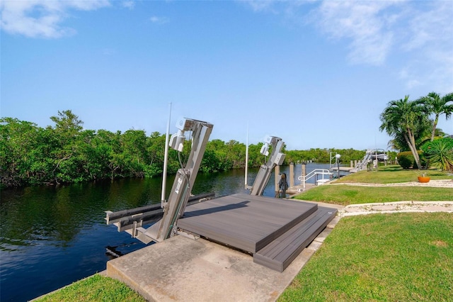 dock area featuring a lawn and a water view