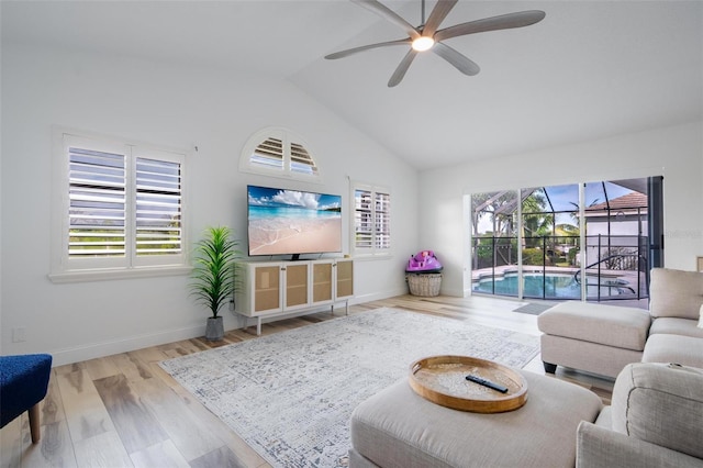 living room with light wood-type flooring, vaulted ceiling, and ceiling fan