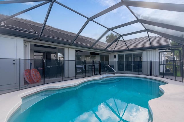 view of swimming pool featuring a lanai and a patio area