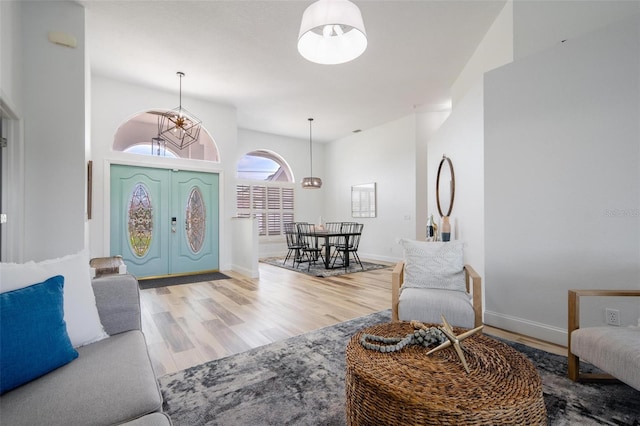 living room with an inviting chandelier and hardwood / wood-style flooring