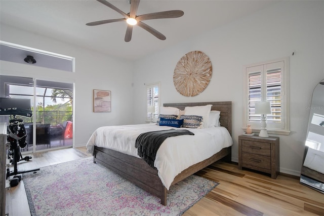 bedroom featuring access to outside, light hardwood / wood-style flooring, and ceiling fan