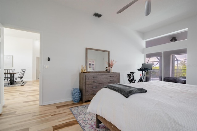 bedroom with access to exterior, ceiling fan, and light hardwood / wood-style floors