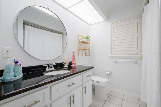 bathroom featuring vanity, toilet, and tile patterned floors