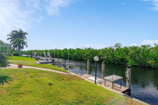 view of dock with a water view and a yard