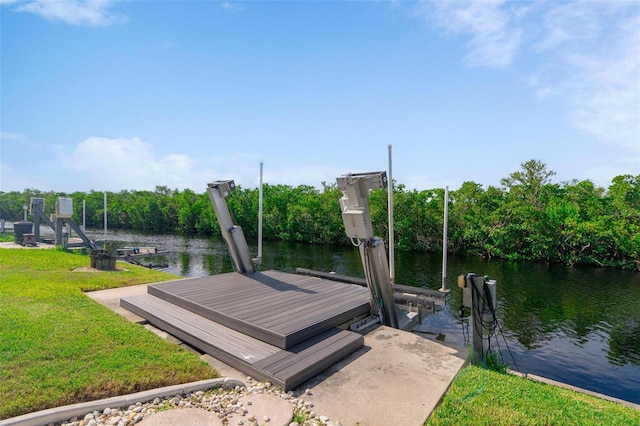 view of dock featuring a water view and a lawn