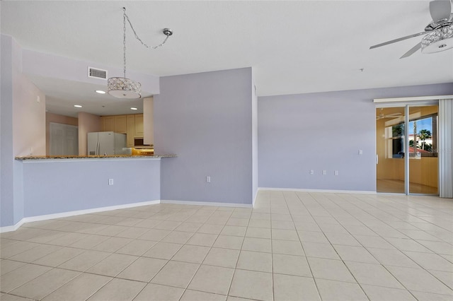 unfurnished living room with light tile patterned flooring and ceiling fan