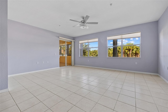 tiled empty room with ceiling fan