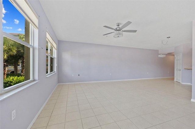 unfurnished room with ceiling fan and light tile patterned floors