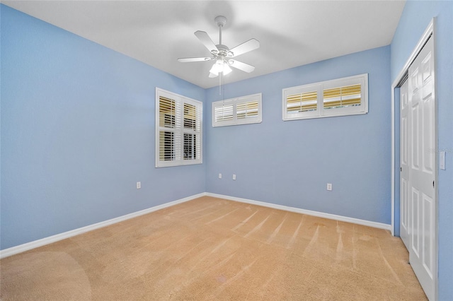 unfurnished bedroom featuring ceiling fan, a closet, and carpet floors