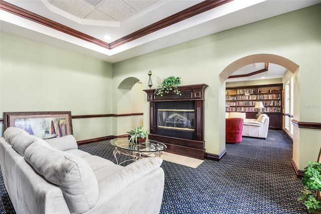 living room with crown molding, a raised ceiling, and dark colored carpet