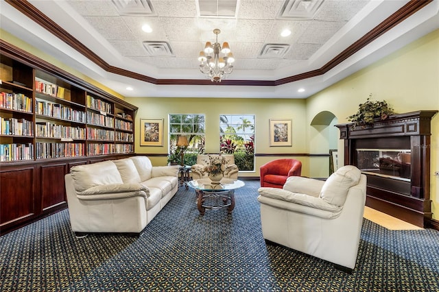 interior space featuring crown molding, dark carpet, a tray ceiling, and an inviting chandelier