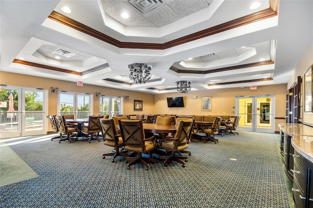 carpeted dining area with ornamental molding, a raised ceiling, and french doors