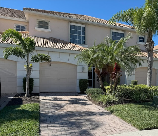 mediterranean / spanish-style home with a garage