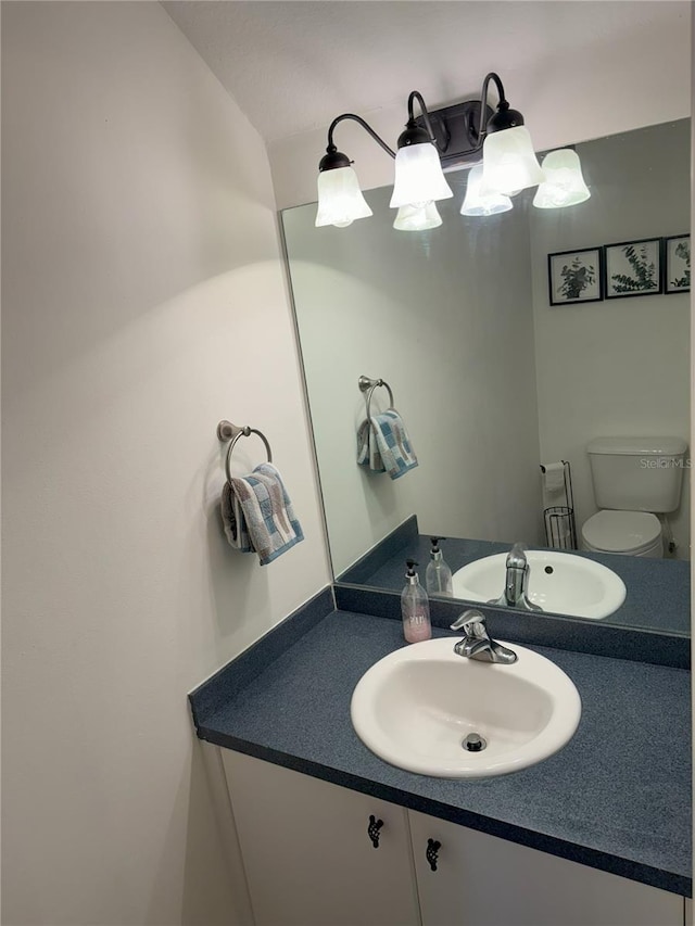 bathroom featuring toilet and vanity