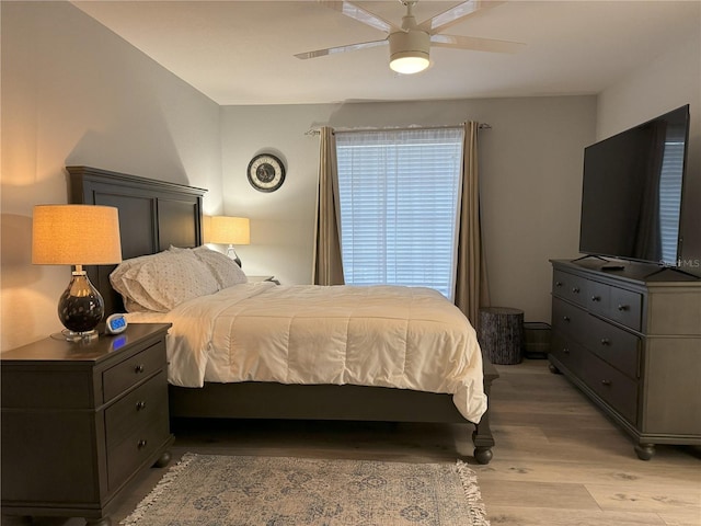 bedroom with ceiling fan and light hardwood / wood-style floors