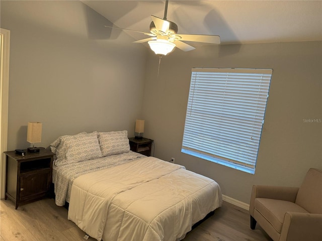 bedroom with ceiling fan and light wood-type flooring