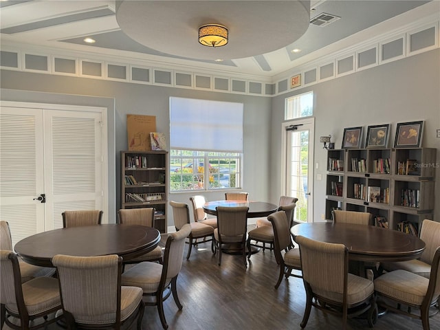 dining space with dark wood-type flooring and crown molding