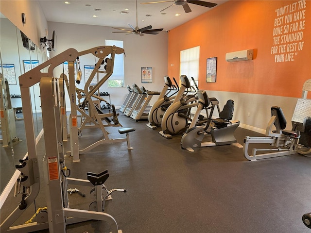 workout area with ceiling fan and a wall mounted air conditioner