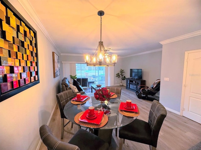 dining room with wood-type flooring, an inviting chandelier, and crown molding