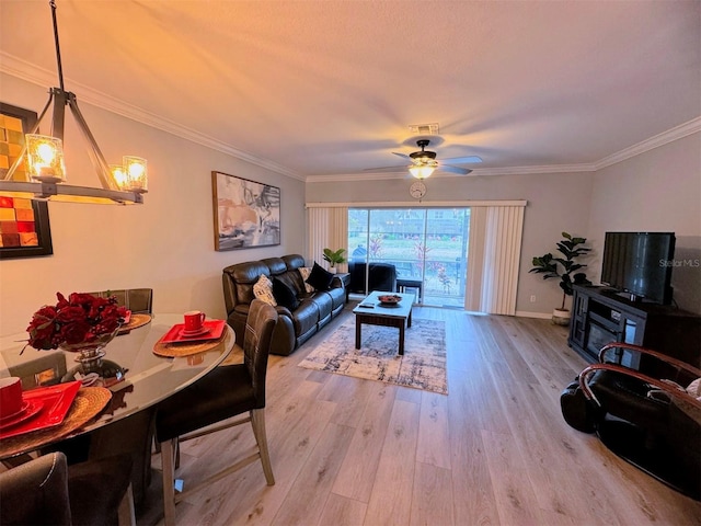 living room with ceiling fan, ornamental molding, and hardwood / wood-style flooring