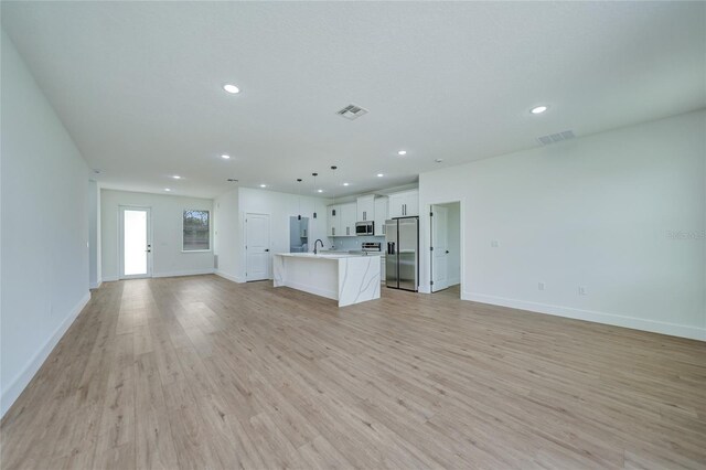 unfurnished living room featuring light hardwood / wood-style floors