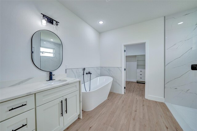 bathroom featuring vanity, hardwood / wood-style floors, and independent shower and bath