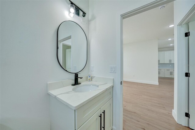 bathroom with vanity and hardwood / wood-style flooring